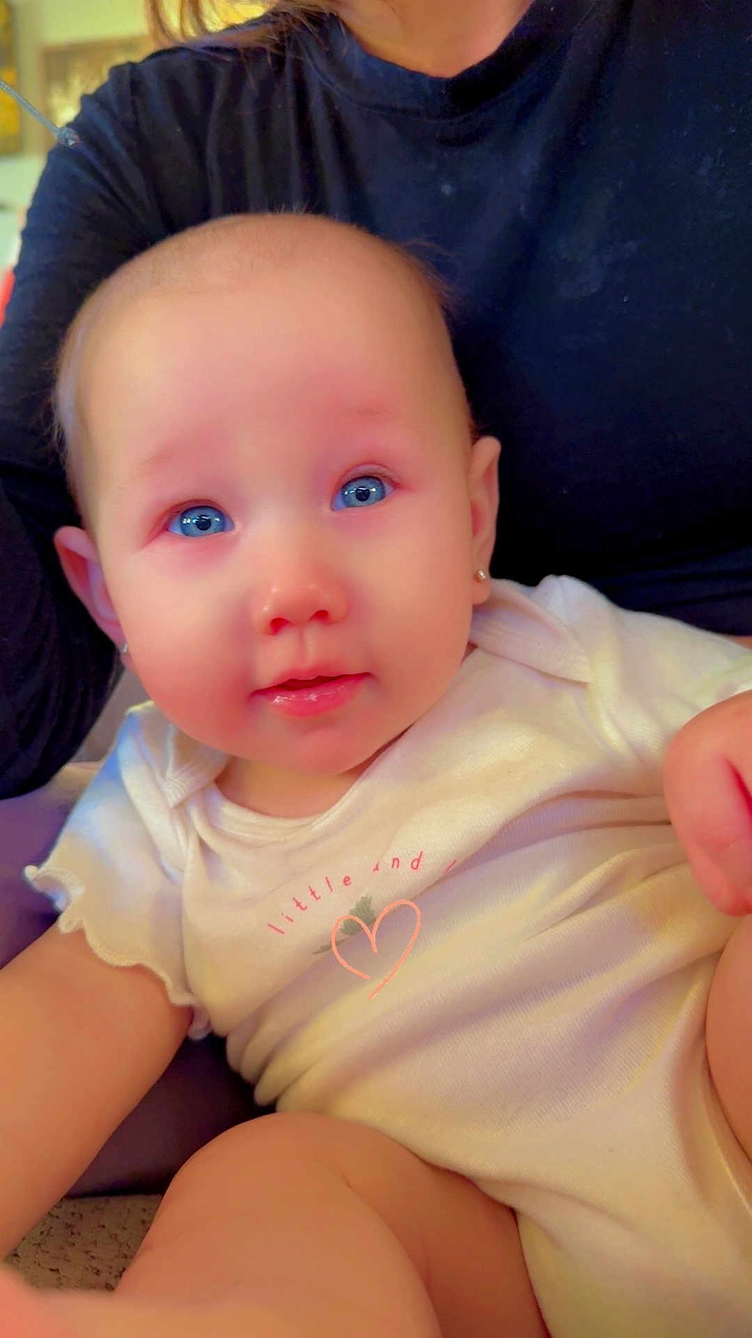 Serayah joined the competition — help win amazing prizes! baby, child, blue_eyes, earrings, white_clothing, close_up, face, person, infant, cute, indoor, soft_lighting, portrait, human, skin, apparel, holding, cuddle, expression, young