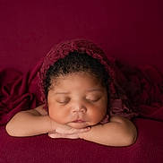 Armani joined the competition — help win amazing prizes! arms, baby, burgundy, child, closeup, curly_hair, cute, fabric, headwear, indoors, infant, knitted_bonnet, newborn, peaceful, portrait, relaxed, resting, skin, sleeping, soft_lighting