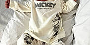 Millie joined the competition — help win amazing prizes! baby, sleeping, infant, mickey_mouse, white_clothing, pajamas, bed, pillow, soft, peaceful, cute, newborn, child, resting, arms_stretched, footwear, cozy, cartoon_print, blanket, indoors