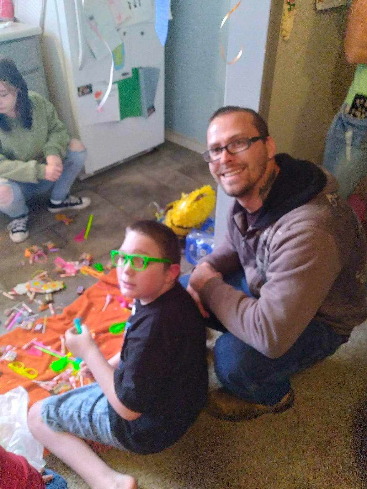 Alexander Or Xander is registered to the contest to win money with this photo: art, child, event, eyewear, flooring, fun, happy, joy, lap, leisure, party, person, plastic, play, recreation, room, sitting, smile, t_shirt, toy