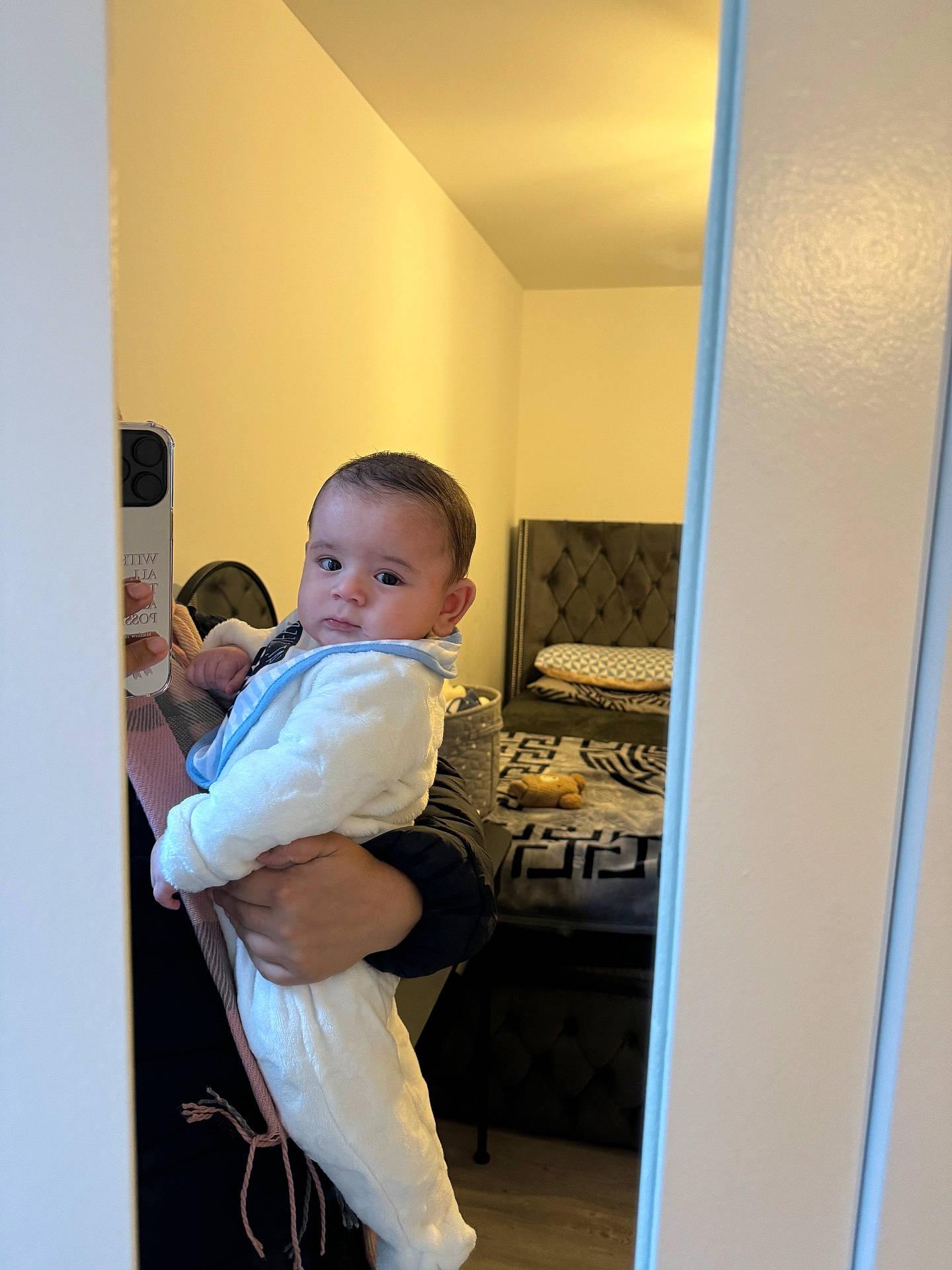 Huraira joined the competition — help win amazing prizes! baby, bed, bedroom, blanket, clothing, face, floor, furniture, hand, head, holding, indoor, infant, mirror, onesie, person, pillow, reflection, stuffed_toy, wall