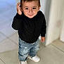 Akim a rejoint le concours — aidez-le/la à gagner de superbes lots ! black_jacket, boy, casual_clothing, child, cute, hand_raised, home, indoor, jeans, light_background, person, playful, portrait, short_hair, smiling, standing, tile_floor, toddler, white_sneakers, young_child