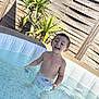 boy, carefree, child, fun, happy, leisure, outdoor, plant, play, pool, recreation, smiling, splash, summer, sunlight, swimming, toy, vacation, water, wooden_fence