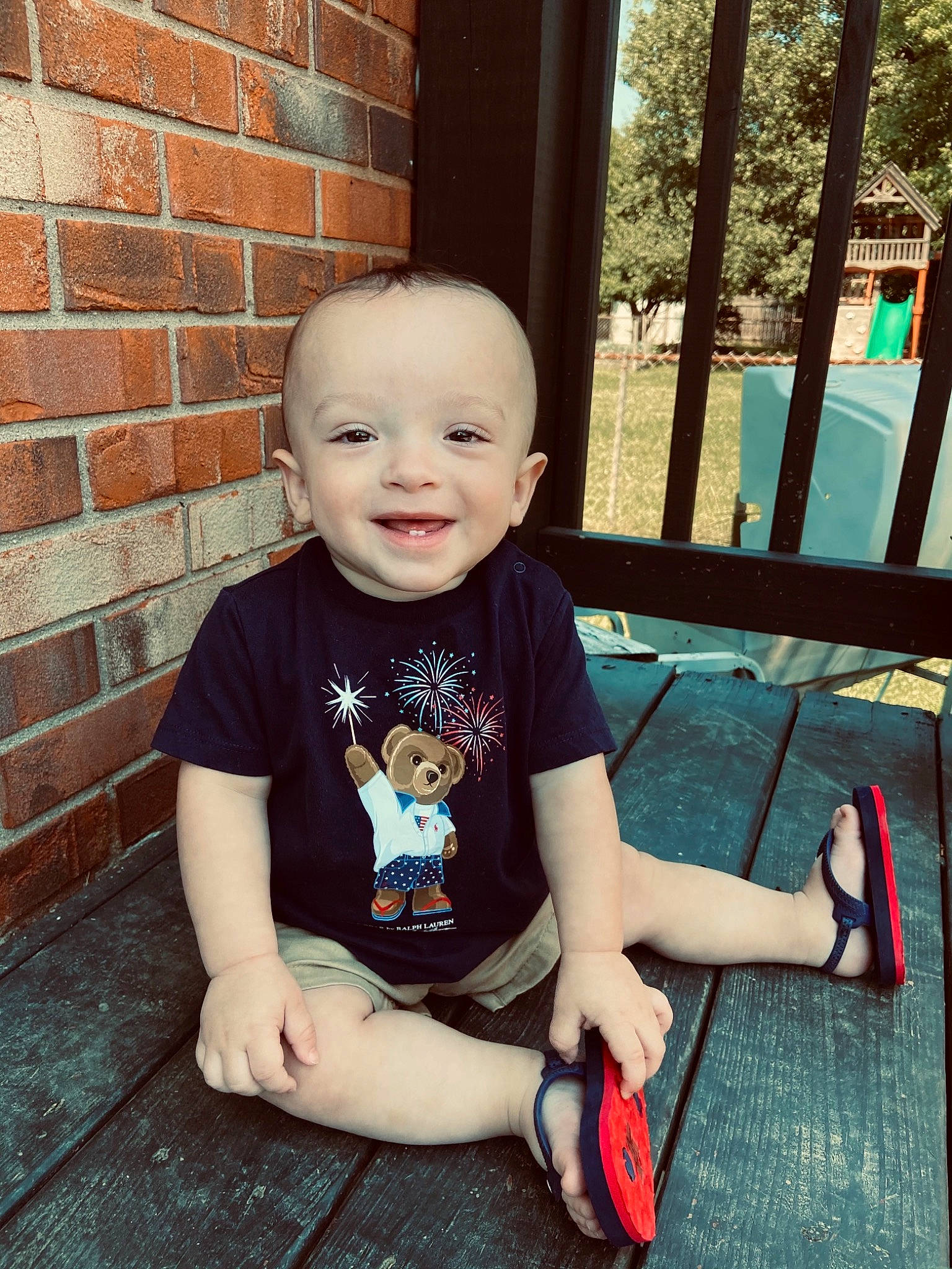 Zayde is registered to the contest to win money with this photo: baby, baby_toddler_clothing, brick, brickwork, child, cool, flooring, grass, happy, joy, leisure, mammal, person, plant, shorts, skin, sleeve, smile, t_shirt, tints_and_shades
