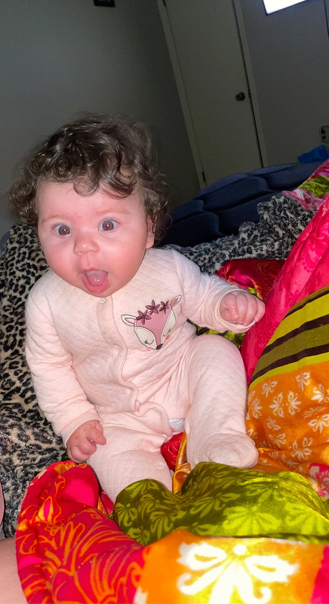 Journey is registered to the contest to win money with this photo: baby, baby_toddler_clothing, baby_toys, black, cheek, child, comfort, event, flooring, fun, grass, happy, linens, pattern, person, pink, room, sitting, sleeve, surprise