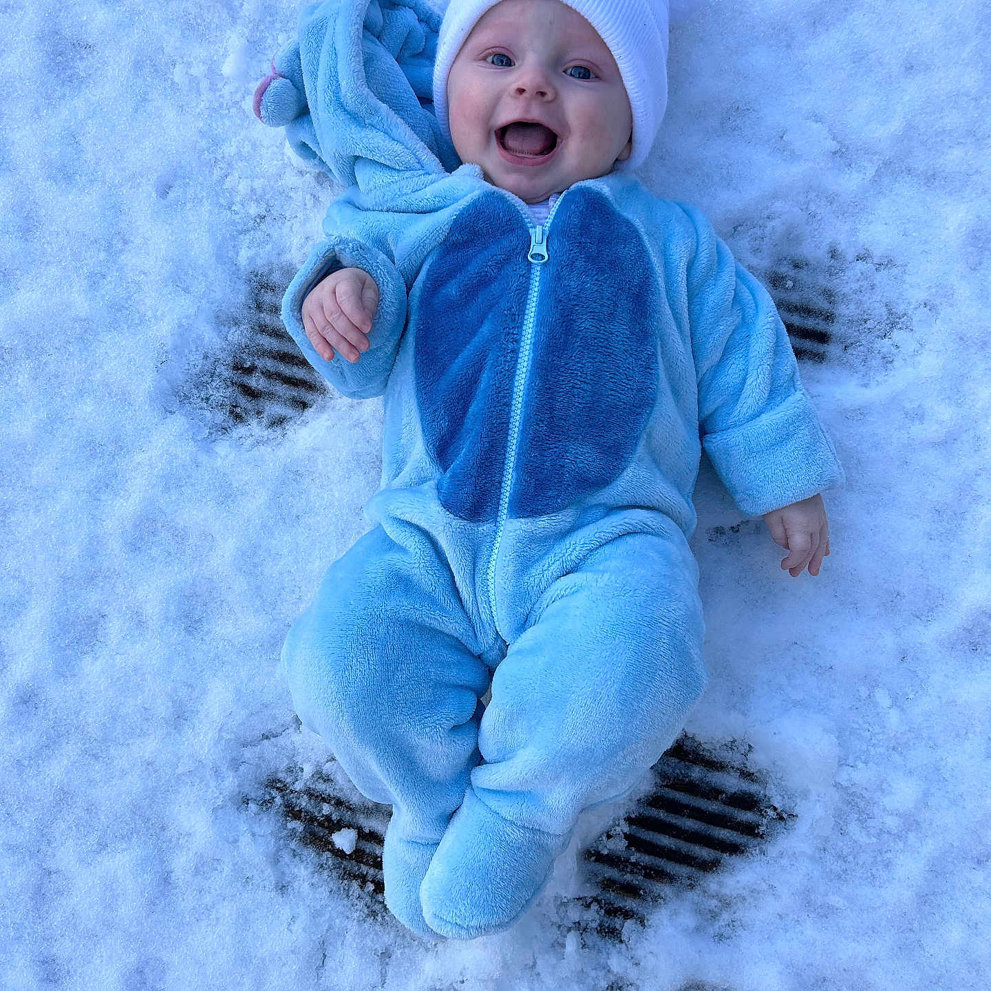 Lucas is registered to the contest to win money with this photo: baby, bonnet, clothing, coat, face, hat, head, hood, ice, jacket, knitwear, nature, outdoors, pants, person, photography, portrait, snow, snowangel, winter