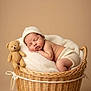 newborn, baby, sleeping, basket, teddy_bear, blanket, knitted_hat, diaper, wooden_plaque, name_tag, cozy, soft, cute, infant, resting, portrait, homedecor, warm_colors, child, peaceful