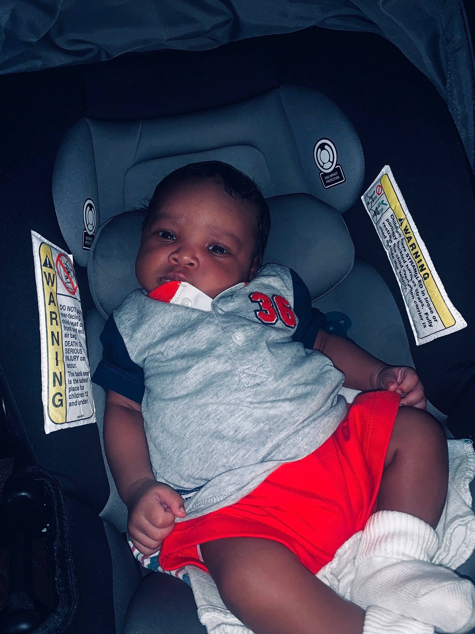 Torrence is registered to the contest to win money with this photo: auto_part, baby, baby_carriage, baby_in_car_seat, baby_products, baby_toddler_clothing, car_seat, child, comfort, cool, eye, finger, fun, knee, lap, mouth, person, red, sock, thigh