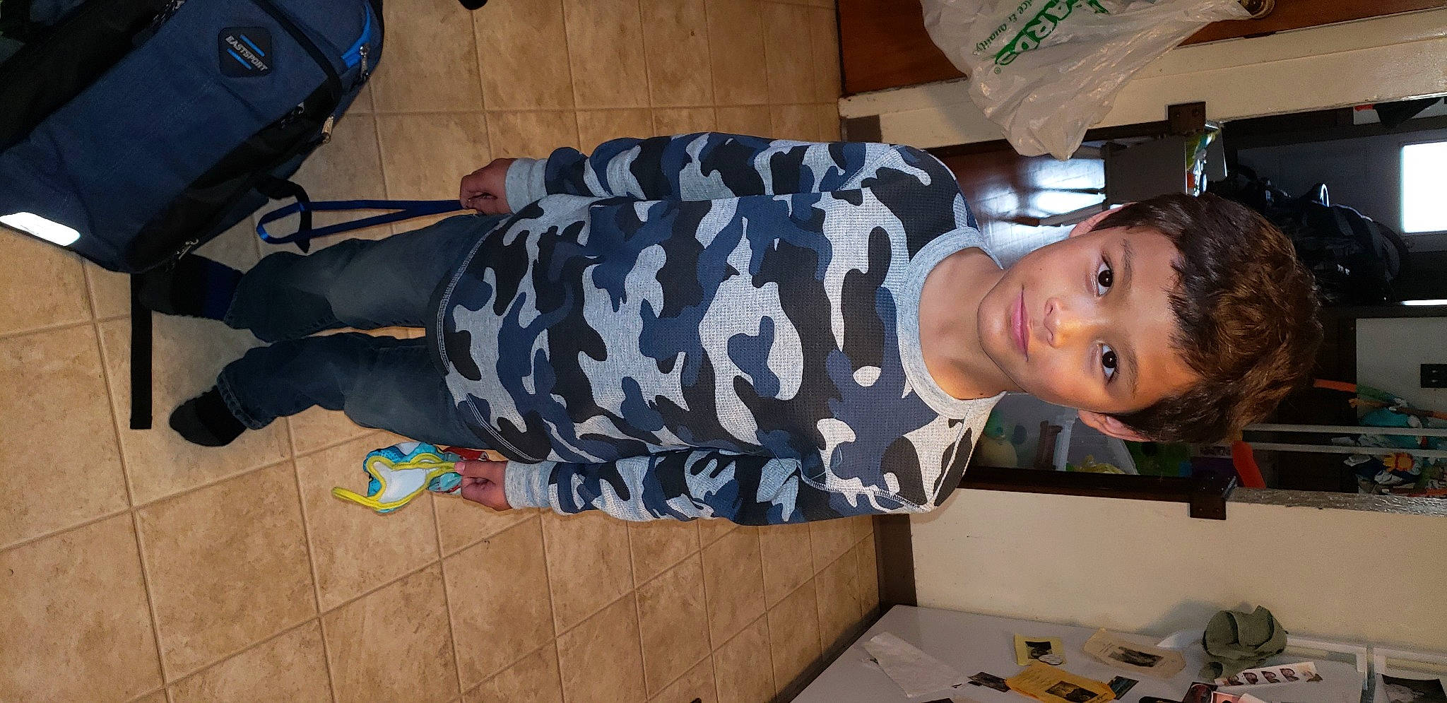 Damien is registered to the contest to win money with this photo: backpack, child, fun, luggage_and_bags, person, room, smile, toddler