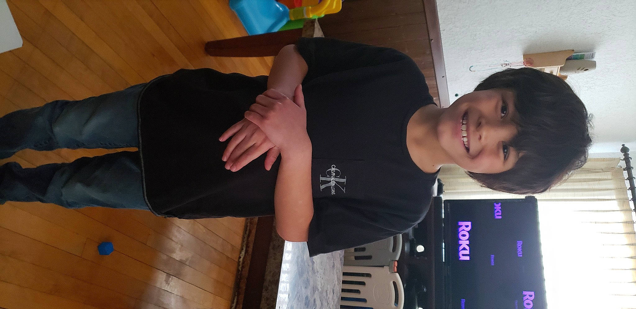 Damien is registered to the contest to win money with this photo: arm, elbow, fun, gesture, happy, hardwood, human_leg, joint, joy, knee, person, room, shoulder, sleeve, smile, sportswear, t_shirt, thigh, thumb, trunk