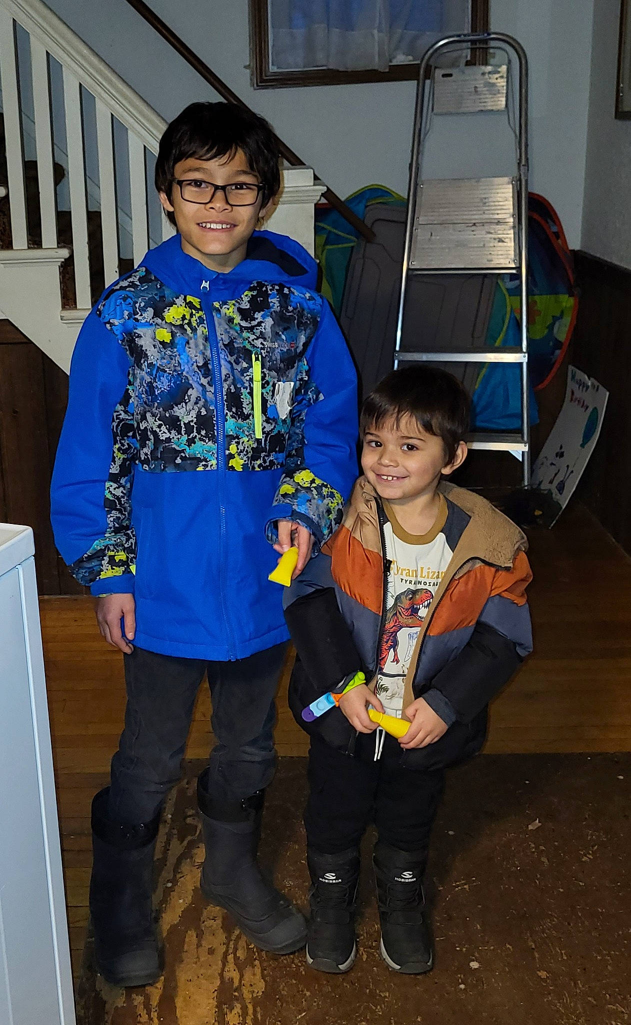 Cillian is registered to the contest to win money with this photo: boot, child, costume, electric_blue, event, fun, hat, joy, motor_vehicle, person, sleeve, smile, standing, tire, toddler, uniform, wheel