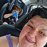 adult, car, car_seat, casual, child, clothing, drinking, face, hair, happy, interior, person, purple_top, safety, seatbelt, selfie, sippy_cup, smile, transportation, window