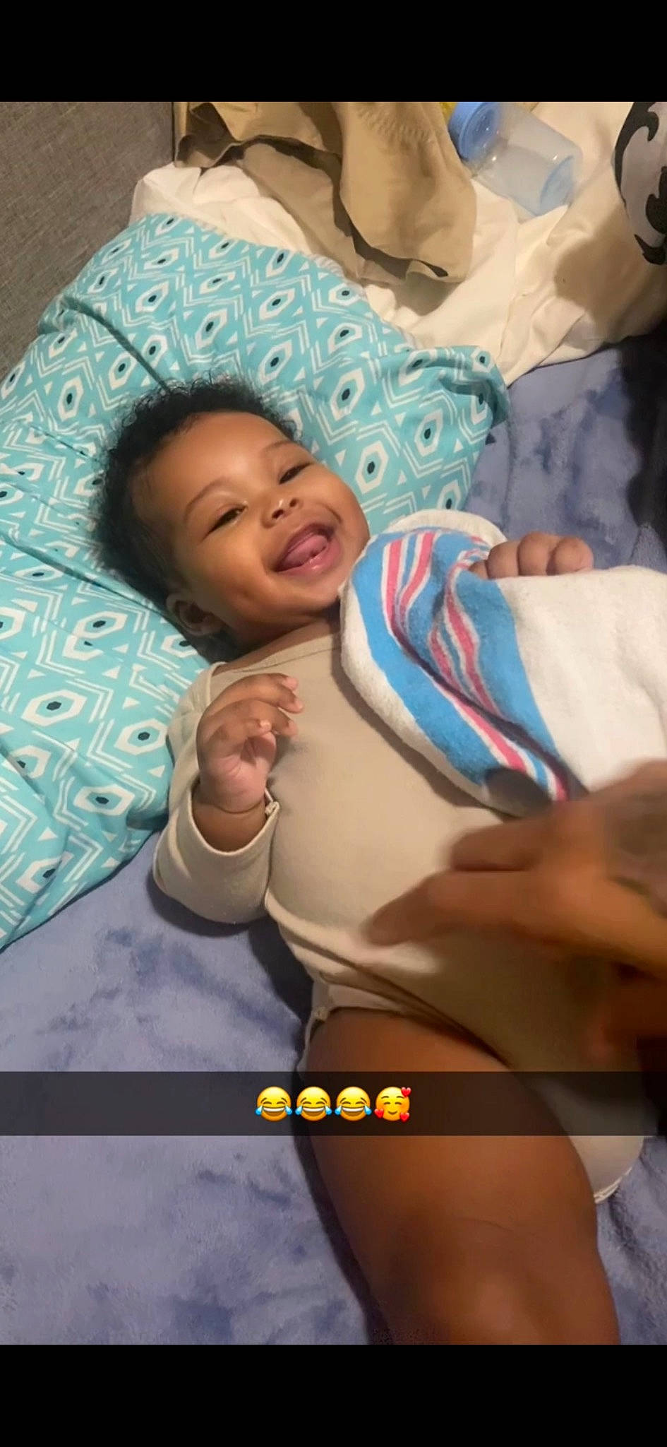 Drue is registered to the contest to win money with this photo: baby, baby_toddler_clothing, cheek, child, comfort, fun, happy, joy, laugh, linens, mouth, person, photo_caption, portrait_photography, skin, smile, thumb, toddler