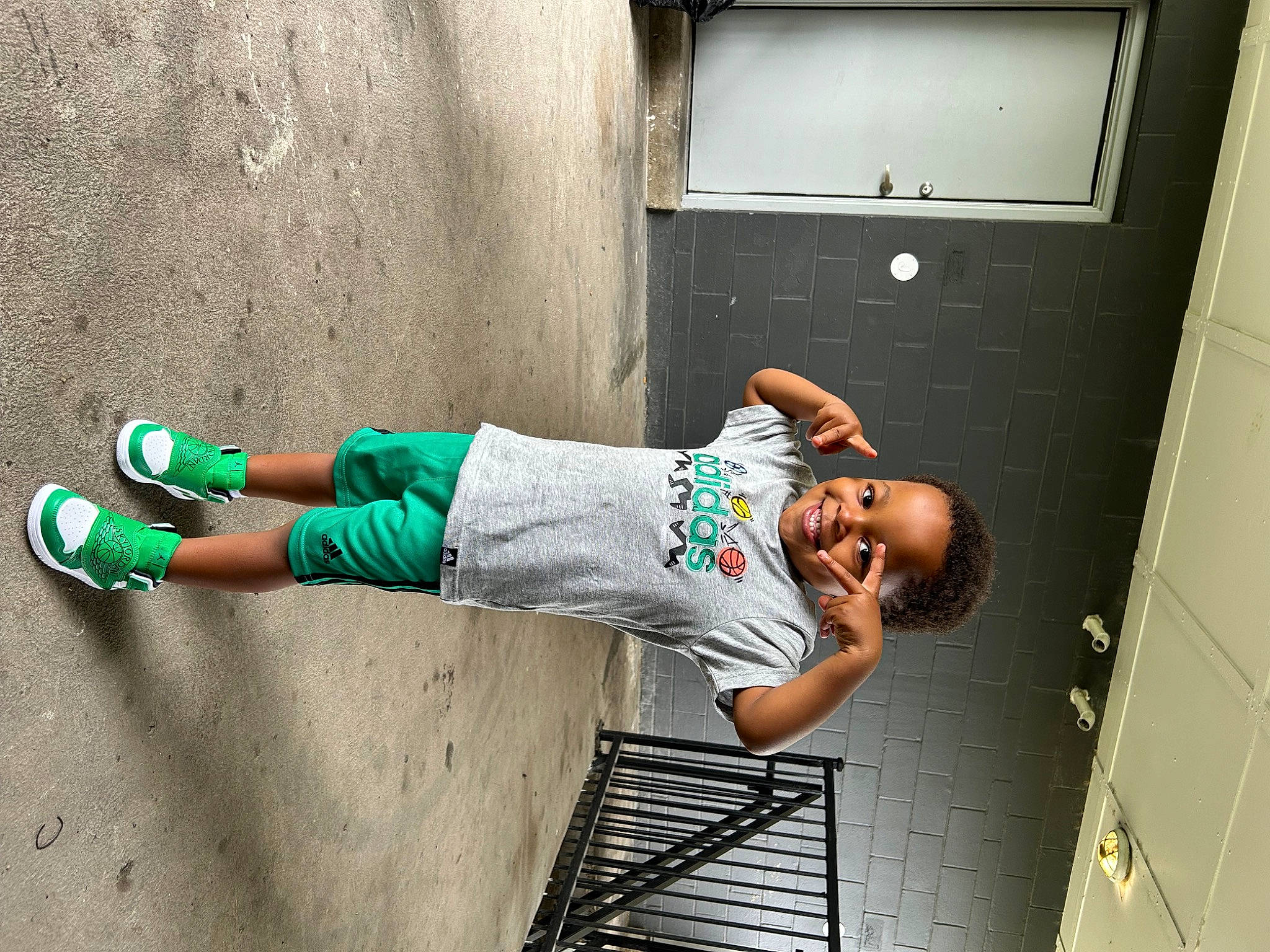 Jamier is registered to the contest to win money with this photo: art, child, concrete, happy, human_leg, joy, knee, leg, person, sandal, sitting, smile, street, t_shirt, thigh, toddler, waist