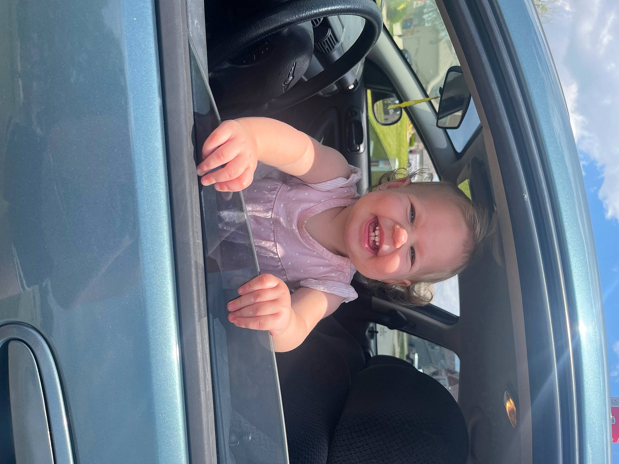 Aries is registered to the contest to win money with this photo: auto_part, automotive_design, automotive_exterior, automotive_lighting, automotive_tire, automotive_wheel_system, car, fender, hand, hood, motor_vehicle, person, rim, smile, tire, toddler, tread, vehicle, vehicle_door, wheel