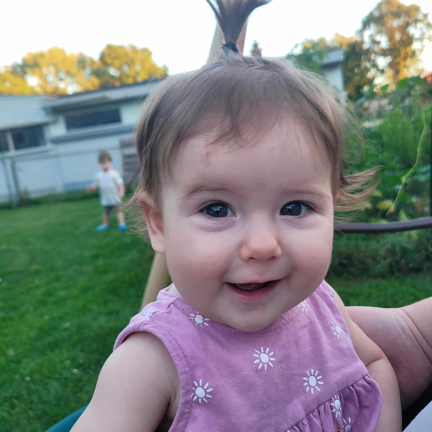 Aurora is registered to the contest to win money with this photo: baby, backyard, bodypart, clothing, dress, face, finger, footwear, grass, hand, head, lawn, nature, outdoors, person, photography, plant, portrait, shoe, yard