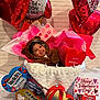 balloon, can, candy, child, clothing, couch, cushion, face, female, food, girl, hat, head, homedecor, person, photography, portrait, sweets, tape, tin