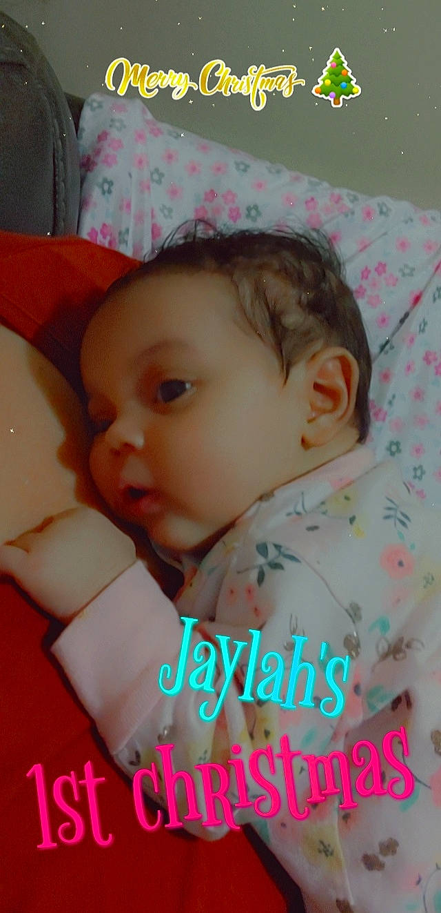 Jaylah is registered to the contest to win money with this photo: baby, baby_products, baby_toddler_clothing, cheek, child, comfort, eye, fashion_accessory, font, happy, linens, lip, pattern, person, pink, portrait_photography, room, sitting, skin, textile