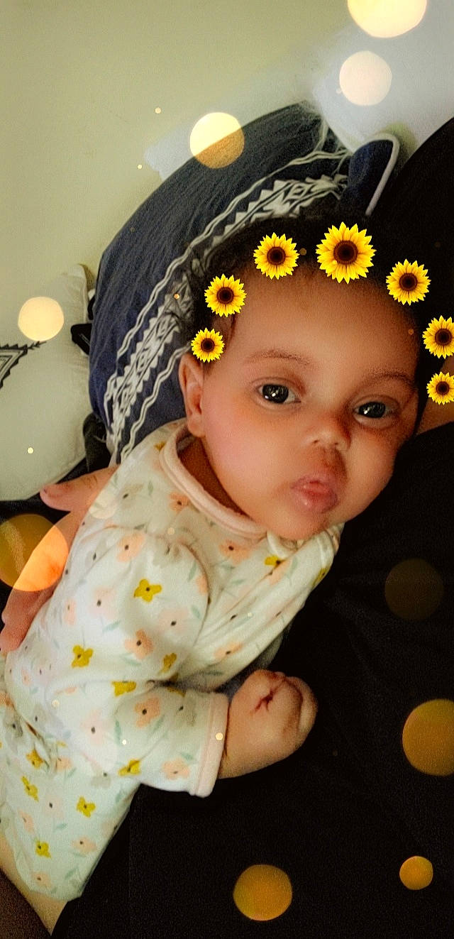 Jaylah joined the competition — help win amazing prizes! baby, baby_toddler_clothing, beauty, cap, child, fashion_accessory, flower, hair_accessory, happy, hat, headband, headpiece, jewellery, lip, people, person, petal, skin, sleeve, textile