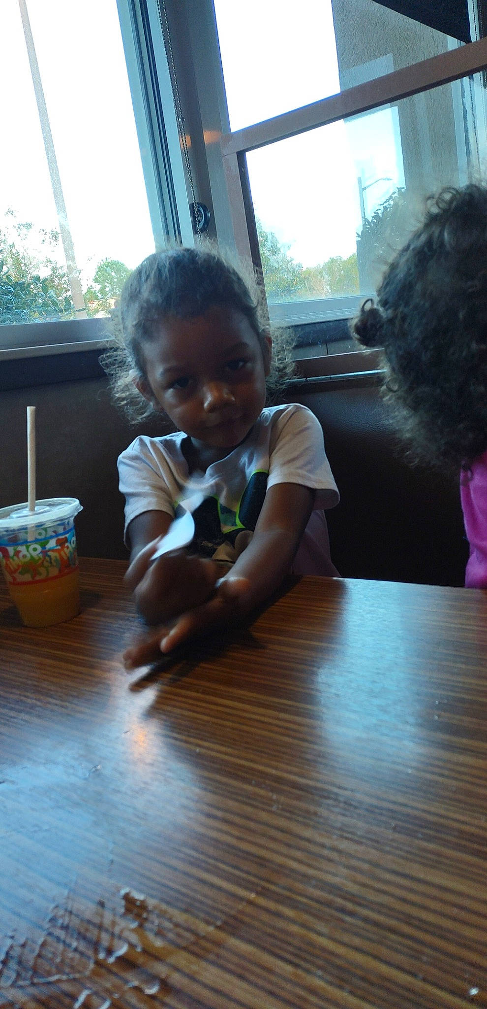 Jordan is registered to the contest to win money with this photo: baby_toddler_clothing, child, floor, flooring, fun, happy, hardwood, leisure, person, room, sitting, skin, smile, table, thumb, toddler, varnish, window, wood, wood_flooring