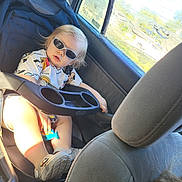 Knox joined the competition — help win amazing prizes! blond_hair, car_interior, car_seat, casual, child, clothing, cool, daylight, footwear, portrait, relaxing, seat, seatbelt, sunglasses, sunlight, toddler, toy, vehicle, window, young_child