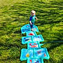 backyard, blue_clothing, child, dog, fun, grass, greenery, happy, hopscotch, inflatable, nature, outdoor, pet, play, splash, summer, sunlight, toddler, water, water_toy