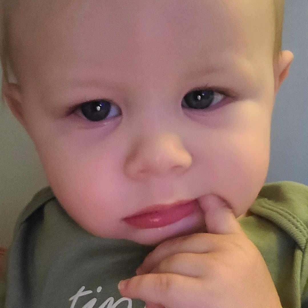 Knox joined the competition — help win amazing prizes! baby, blonde_hair, casual_clothing, child, close_up, curious, cute, expression, face, finger_in_mouth, green_shirt, hand, indoors, pensive, person, portrait, skin, text_on_clothing, toddler, young_child