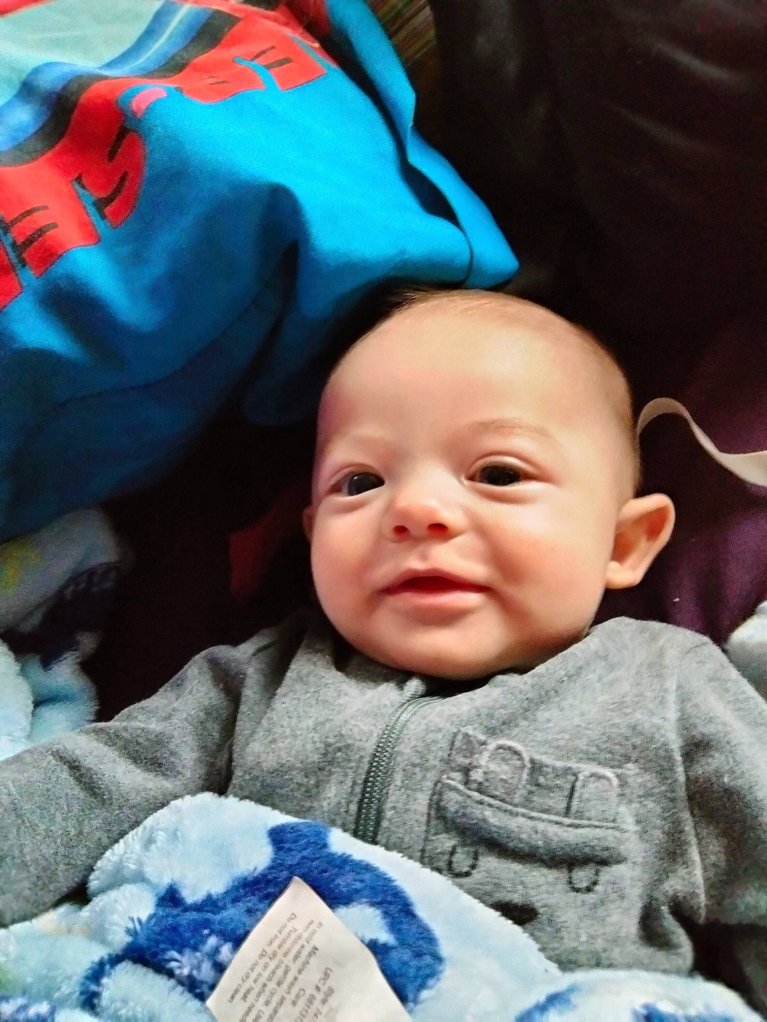 Myles is registered to the contest to win money with this photo: azure, baby, baby_toddler_clothing, blue, cheek, comfort, cool, face, facial_expression, happy, headgear, human, mammal, nose, organ, person, product, skin, smile, textile