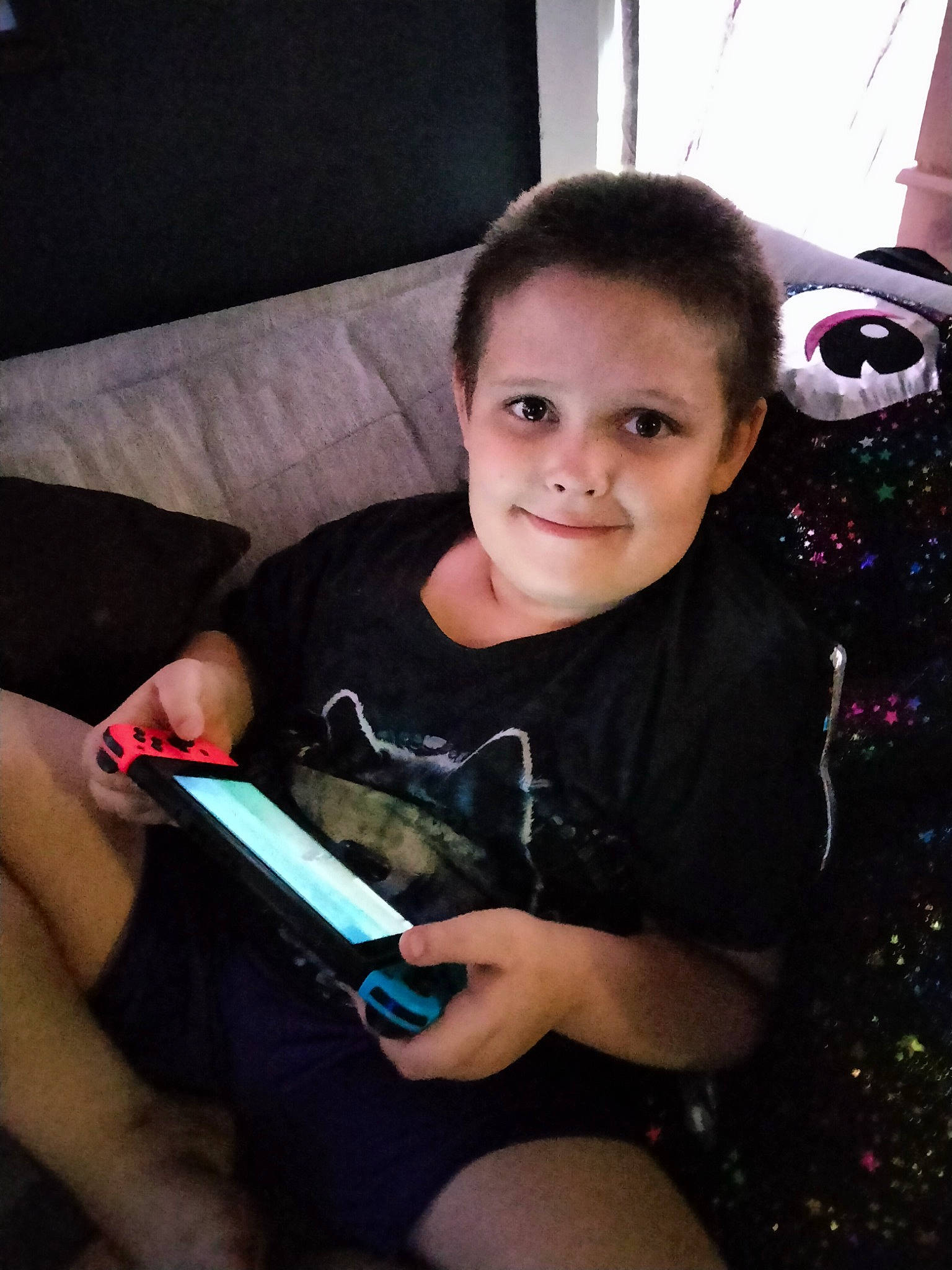 Robert is registered to the contest to win money with this photo: child, communication_device, couch, event, face, finger, flash_photography, fun, gadget, hand, happy, human_leg, joy, lap, mobile_device, mobile_phone, nail, person, smile, standing