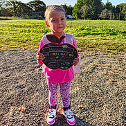 Mariana is registered to the contest to win money with this photo: child, clothing, face, female, footwear, girl, grass, head, nature, outdoors, pants, park, person, photography, plant, portrait, shoe, sneaker, soil, walking