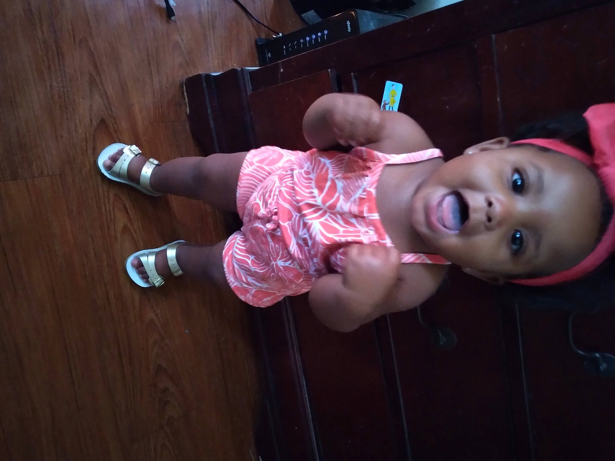 A'Niyah is registered to the contest to win money with this photo: baby, baby_products, baby_toddler_clothing, cheek, child, flash_photography, flooring, foot, fun, happy, hardwood, hat, human_leg, knee, person, pink, smile, sock, thigh, toddler