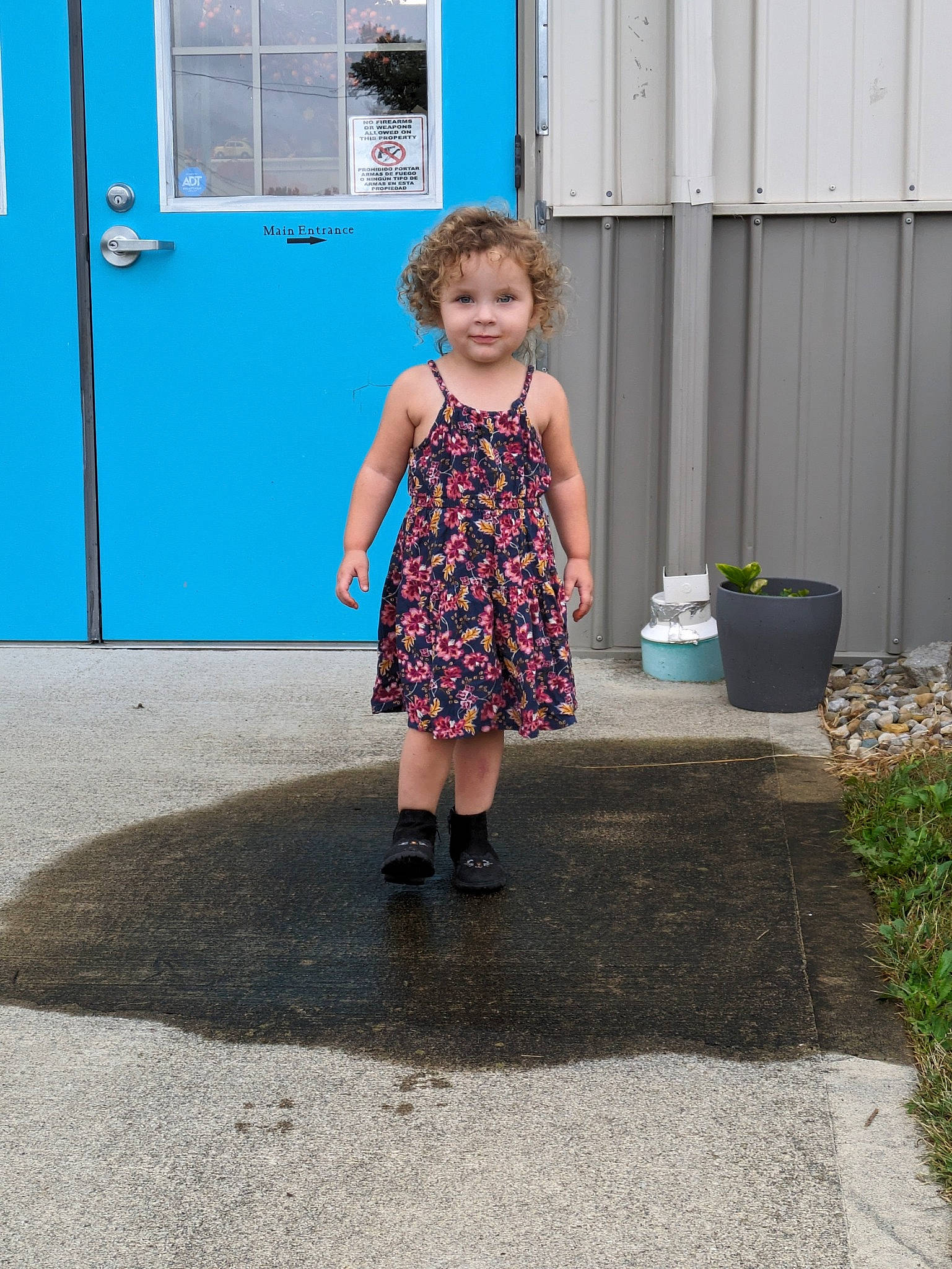 Julieanne is registered to the contest to win money with this photo: asphalt, child, concrete, door, dress, electric_blue, flooring, fun, human_leg, joy, magenta, pattern, person, road, road_surface, sidewalk, sitting, standing, toddler, vacation