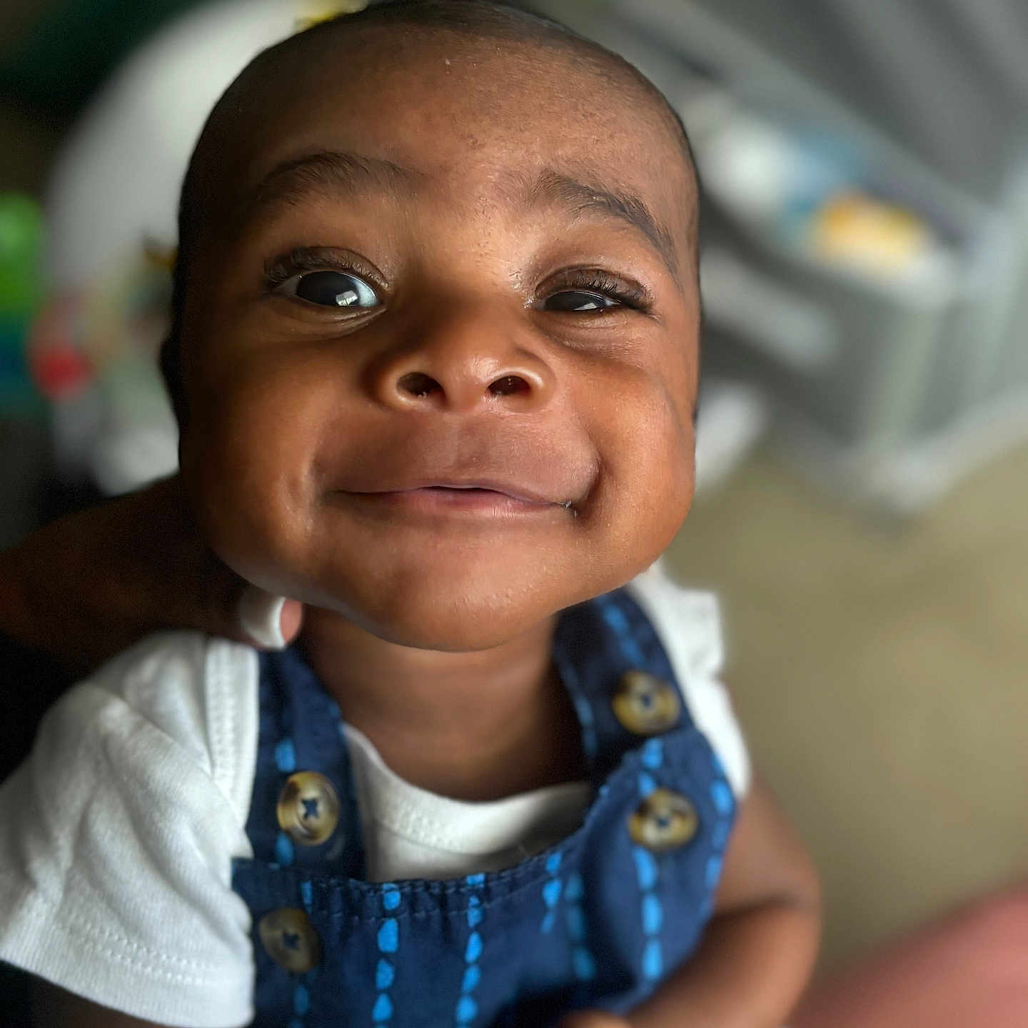 Tylin joined the competition — help win amazing prizes! baby, smile, close_up, face, child, infant, blue_outfit, white_shirt, button, happy, cute, portrait, indoors, person, skin, head, eyes, expression, young, baby_clothing