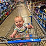 baby, child, shopping_cart, supermarket, grocery_store, smiling, laughing, portrait, sitting, floral_clothing, infant, aisle, retail, shopping, paper_products, toilet_paper, shelves, indoor, happy, family_outing