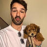 Abbie a rejoint le concours — aidez-le/la à gagner de superbes lots ! accessory, animal, beige_wall, brown_hair, casual, cute, dog, facial_hair, friendly, holding, indoor, leash, man, person, pet, portrait, puppy, smiling, white_shirt, young_adult