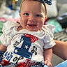 baby, child, smiling, headband, white_clothing, red_white_blue, celebration, 4th_of_july, portrait, closeup, indoor, happy, cute, infant, festive, ribbon, polka_dot, sitting, person, holiday