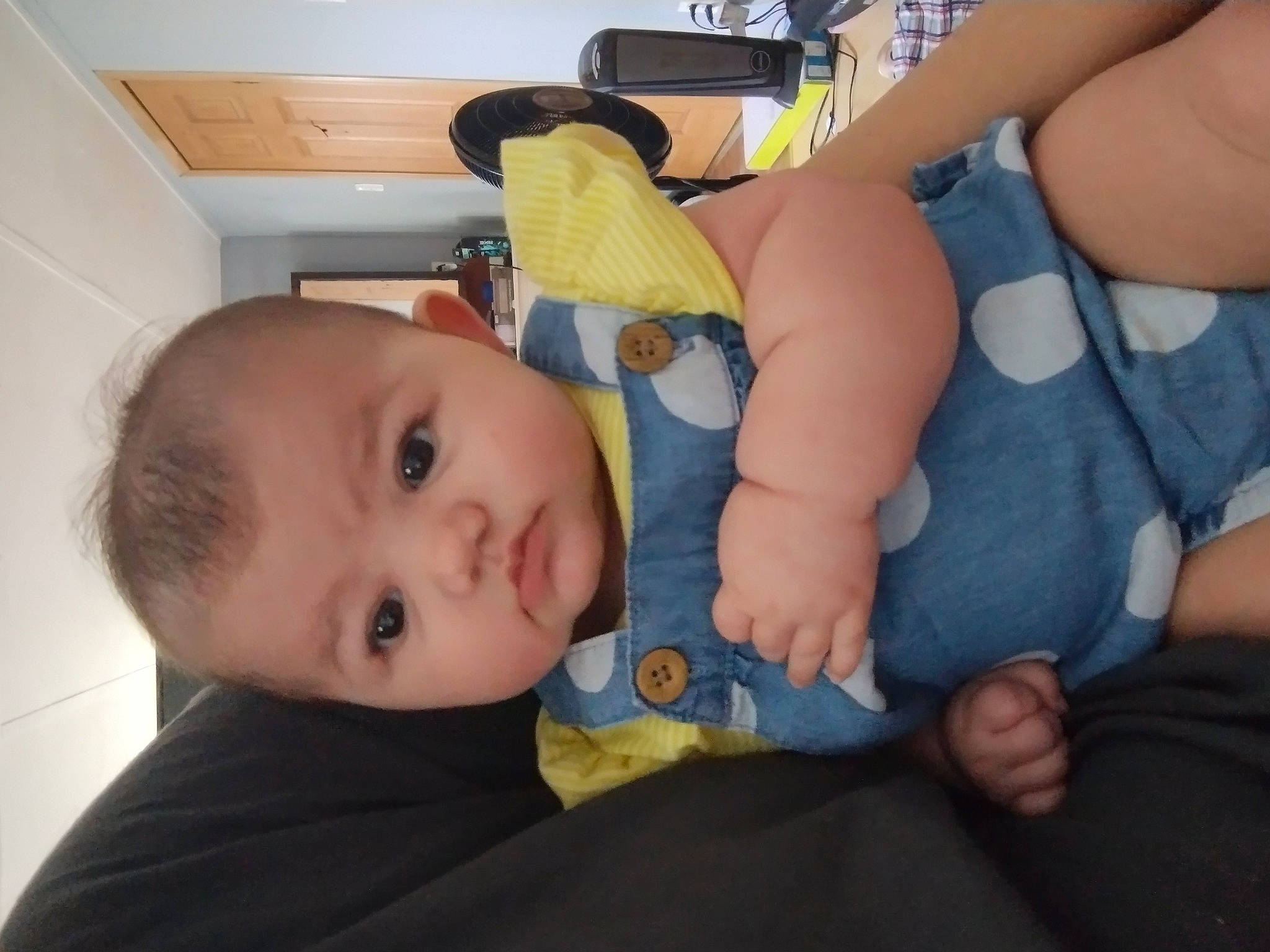 Amyah is registered to the contest to win money with this photo: arm, baby, baby_toddler_clothing, cheek, comfort, facial_expression, finger, fun, gesture, hand, human_body, joint, mouth, nose, person, product, skin, textile, thigh, thumb