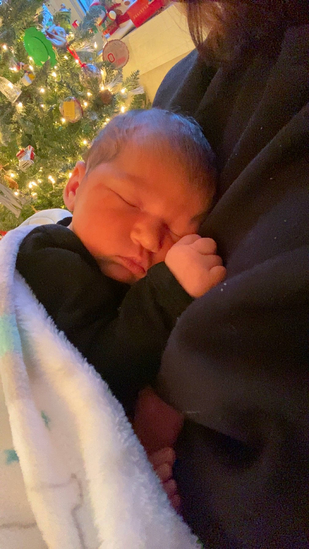 Hadleigh is registered to the contest to win money with this photo: baby, baby_toddler_clothing, cheek, child, christmas_decoration, christmas_ornament, christmas_tree, comfort, event, eye, fun, happy, head, holiday, lap, linens, ornament, person, sitting, toddler