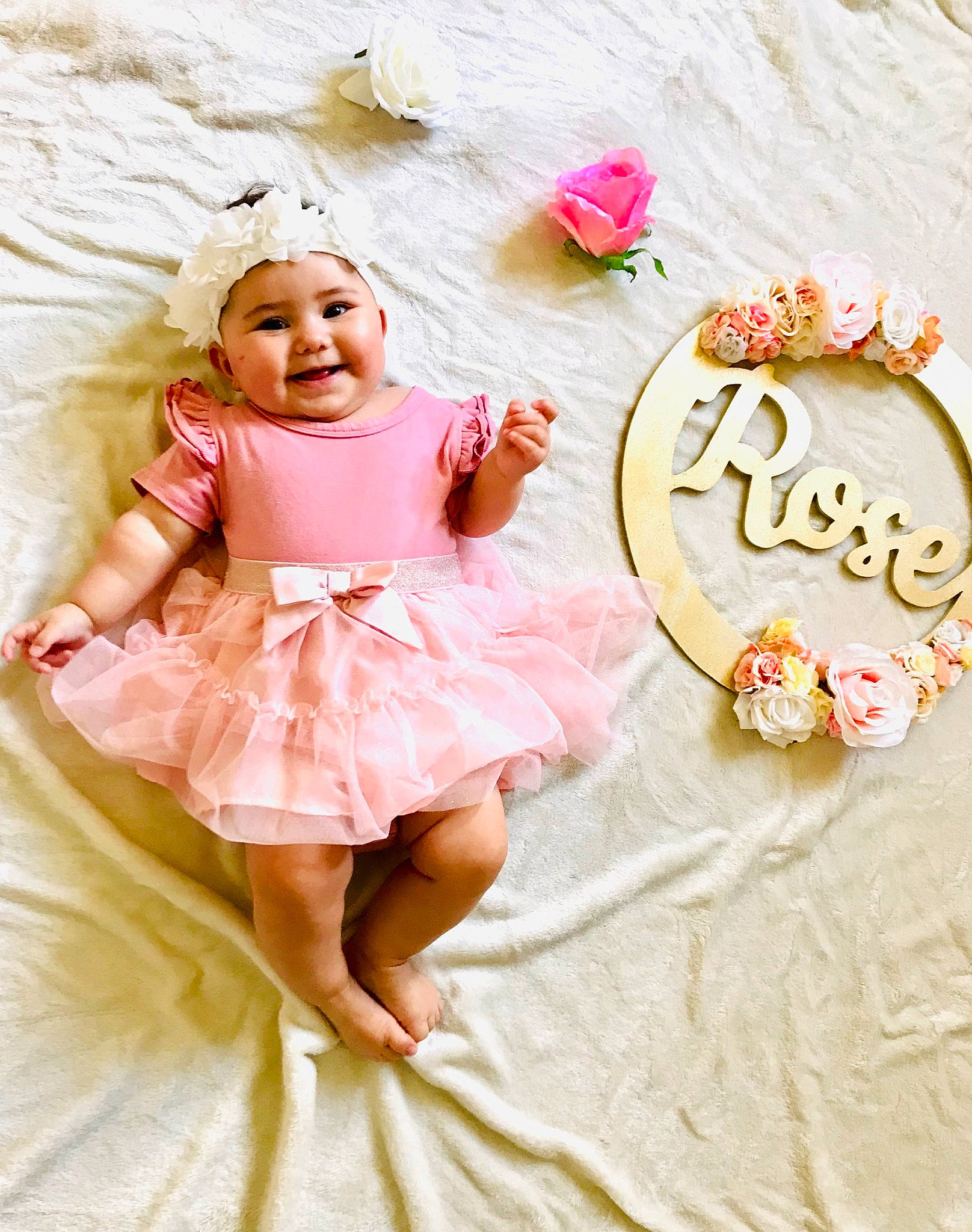 Rose participe au concours pour gagner de l'argent avec cette photo : baby, baby_toddler_clothing, child, clothing, day_dress, dress, face, flower, happy, headgear, headwear, joy, magenta, mythical_creature, peach, person, petal, pink, ruffle, sleeve