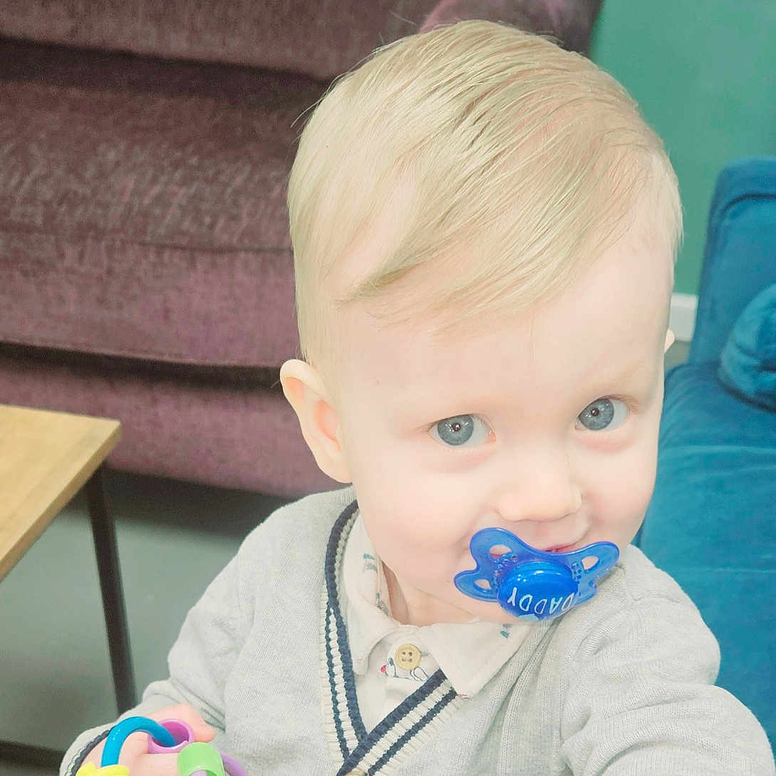 Blake joined the competition — help win amazing prizes! architecture, baby, bodypart, building, couch, face, finger, food, furniture, hand, head, indoors, livingroom, person, photography, portrait, room, sitting, table, toy