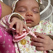 Clara is registered to the contest to win money with this photo: baby, sleeping, pacifier, hand, headband, floral_clothing, closeup, infant, peaceful, soft_lighting, pink, newborn, cute, resting, person, child, indoors, fabric, skin, portrait