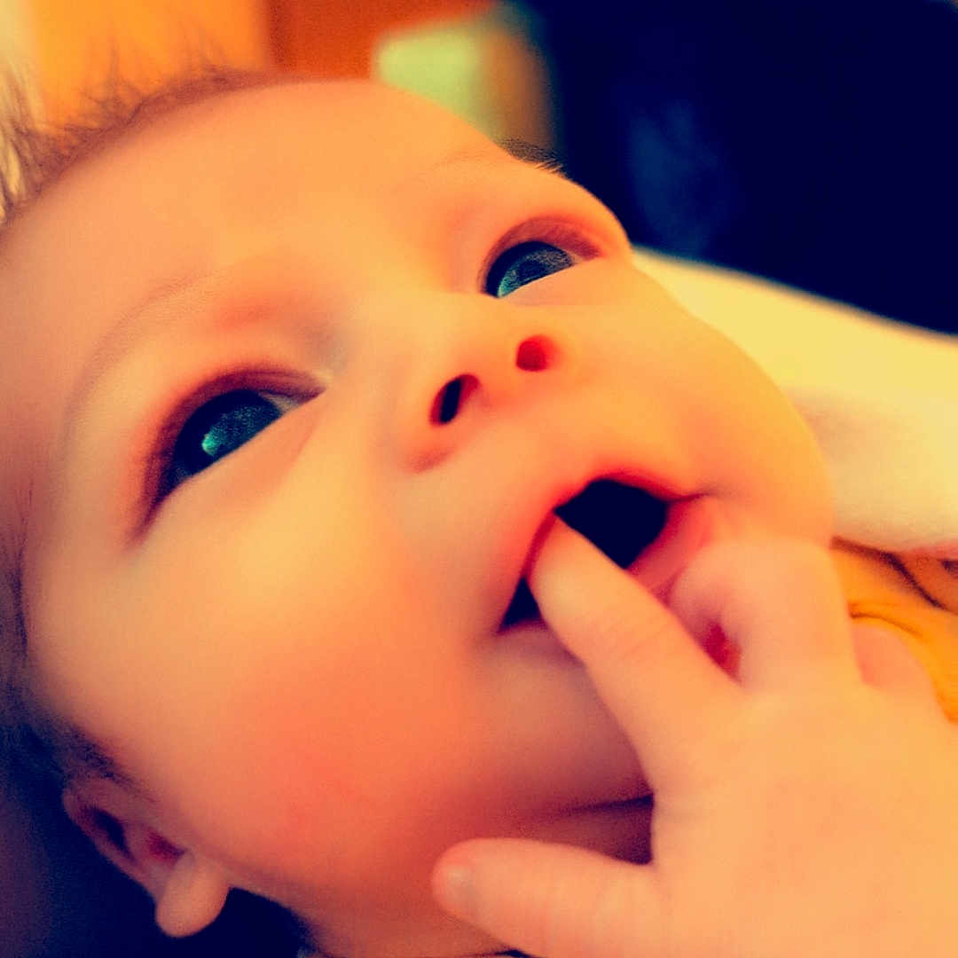 Thanos is registered to the contest to win money with this photo: baby, bodypart, couch, ear, eating, face, finger, food, furniture, hand, happy, head, laughing, mouth, newborn, person, photography, portrait, smile, teeth