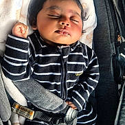 Walaa joined the competition — help win amazing prizes! baby, sleeping, car_seat, blanket, striped_clothing, infant, child, peaceful, cute, safety_harness, black_and_white, soft_texture, indoors, portrait, resting, young_child, head, hand, foot, cozy