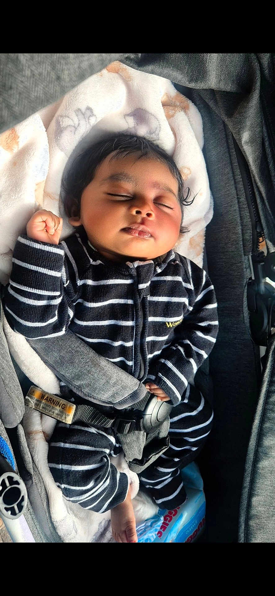 Walaa joined the competition — help win amazing prizes! baby, sleeping, car_seat, blanket, striped_clothing, infant, child, peaceful, cute, safety_harness, black_and_white, soft_texture, indoors, portrait, resting, young_child, head, hand, foot, cozy