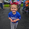 Mackenzie joined the competition — help win amazing prizes! child, smiling, blue_jersey, american_flag, headband, outdoor, people, crowd, celebration, festive, young, happy, portrait, event, costume, red, white, blue, street, fun