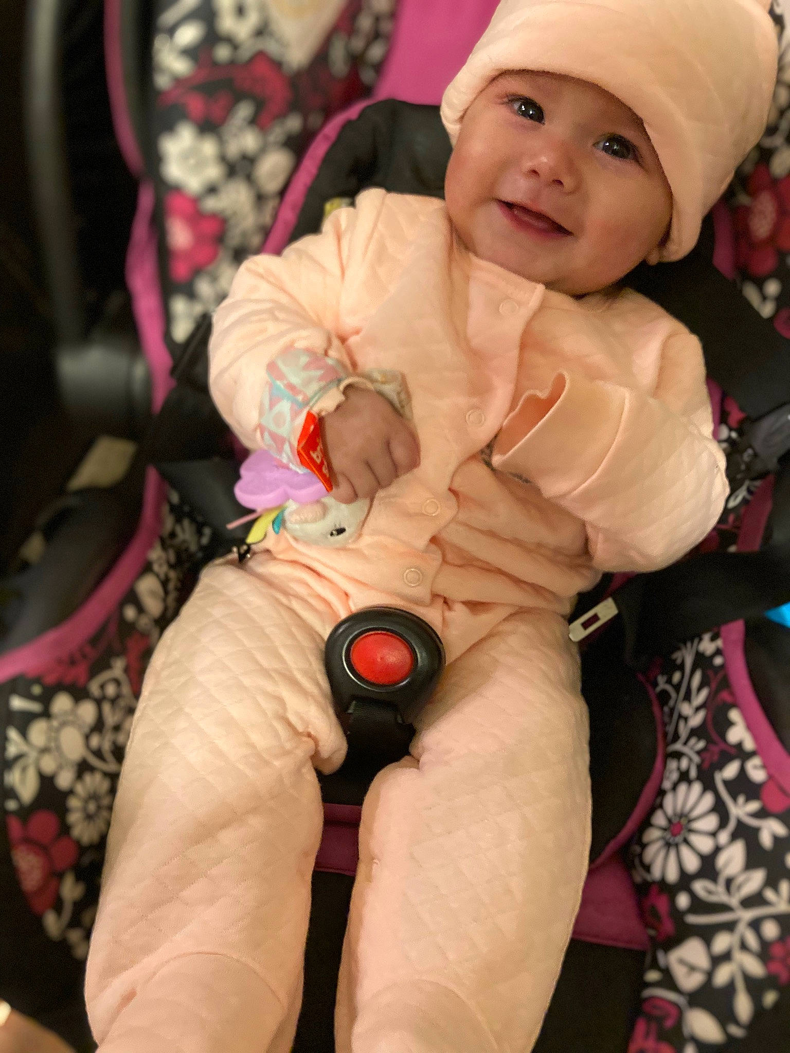 Ellie Kauhi is registered to the contest to win money with this photo: baby, baby_toddler_clothing, cap, cheek, comfort, eye, face, finger, happy, head, headwear, human_body, joy, lap, mammal, muscle, person, pink, skin, smile