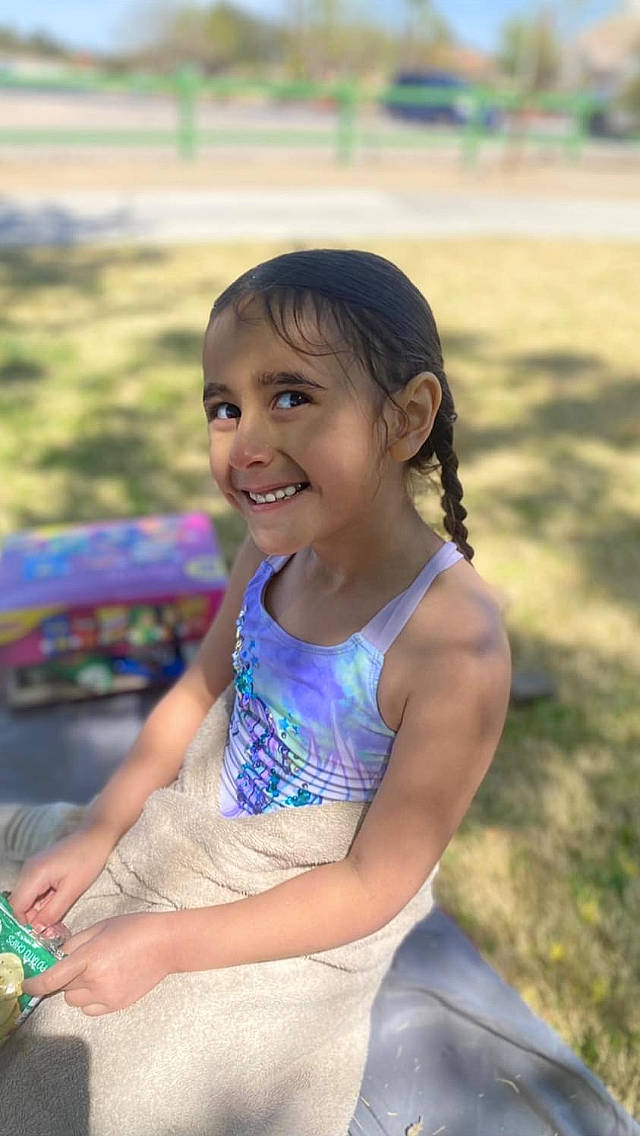 Elaina Kauhi joined the competition — help win amazing prizes! abdomen, ballet_tutu, child, child_model, event, facial_expression, fun, grass, happy, iris, joy, laugh, leisure, person, play, recreation, sitting, skin, smile, summer