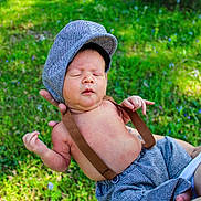 Wyatt joined the competition — help win amazing prizes! baby, infant, child, outdoor, greenery, grass, flower, hat, suspenders, clothing, nature, person, cute, portrait, hands, skin, relaxing, peaceful, daylight, holding