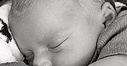 Paxton joined the competition — help win amazing prizes! baby, infant, sleeping, nap, portrait, black_and_white, peaceful, cozy, blanket, textile, close_up, face, head, closed_eyes, ear, cheek, arm, snuggling, indoor, monochrome