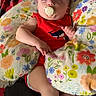 Karliah joined the competition — help win amazing prizes! baby, blanket, child, colorful, comfort, cozy, cute, face, floral_pillow, indoor, infant, leg, pacifier, peaceful, red_onesie, resting, sleeping, small_hands, soft, white_socks